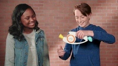 Two kids enjoy a game of Bop It! together.