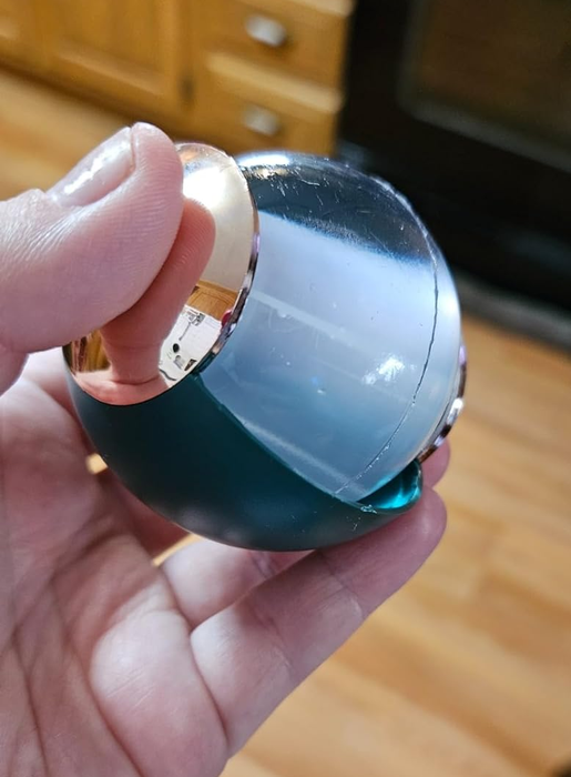 A person holding a green washable gel lint roller
