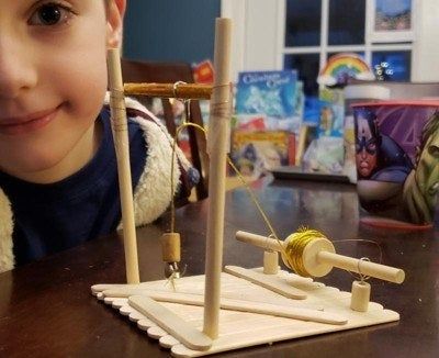 A child proudly displays their creation.