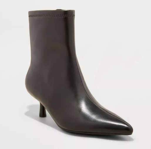 Black ankle boots with a pointed toe and a comfortable low heel, designed for chic and versatile wear