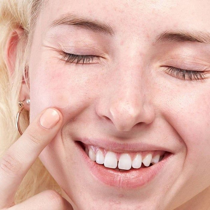 A person pointing to a skin patch