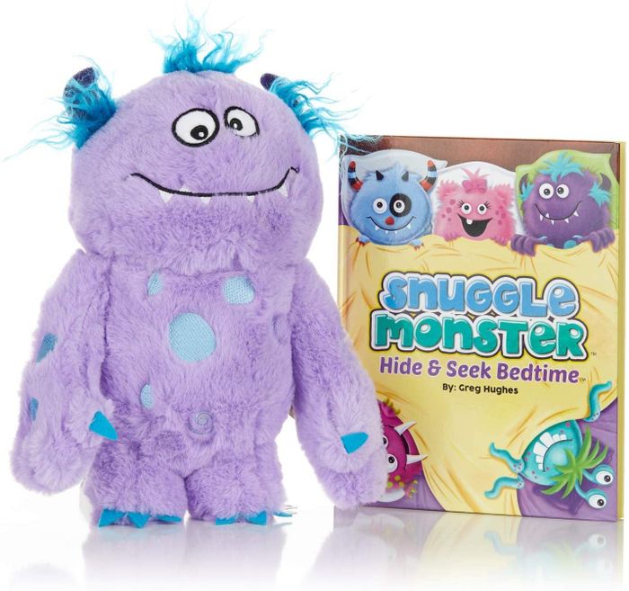 A purple plush monster with a book titled