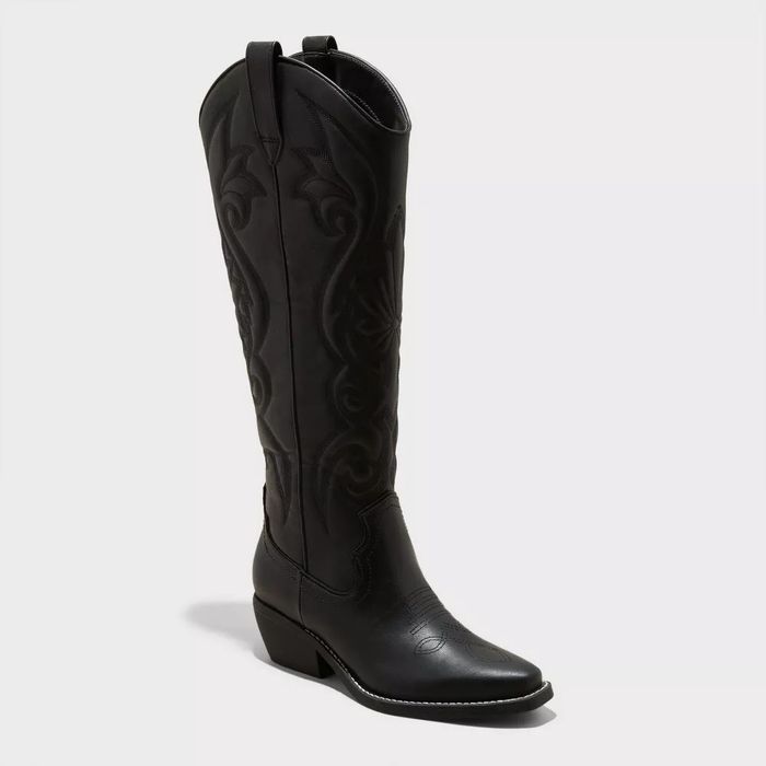 Black cowboy boot with intricate stitching and a low heel, presented against a plain background to emphasize its sleek design