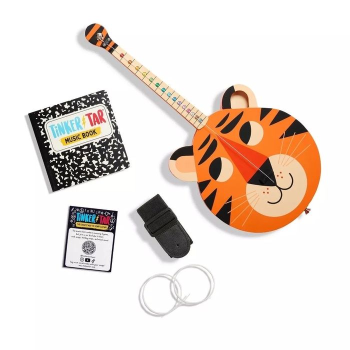 A tiger-themed ukulele kit featuring a tiger-faced ukulele, a music book, strap, picks, and strings, offering everything a young musician needs to get started on their musical journey.