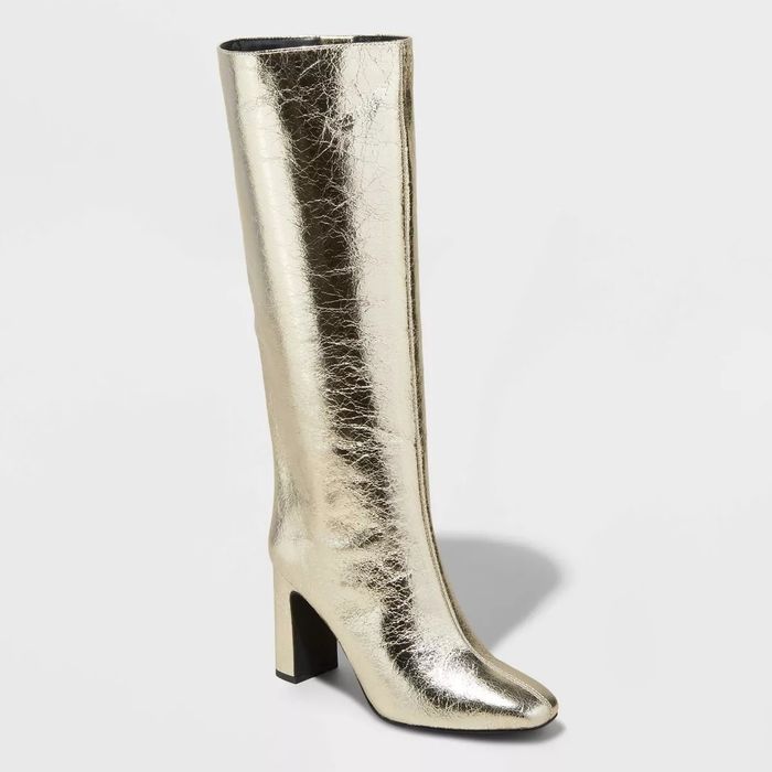 Chic metallic knee-high boots with a block heel, adding a bold touch to any outfit