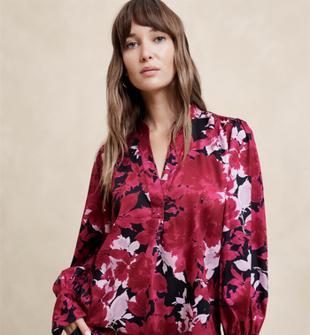 Model wearing a floral-patterned blouse