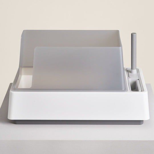 Sleek, modern dish rack complete with a drying mat and a convenient utensil holder