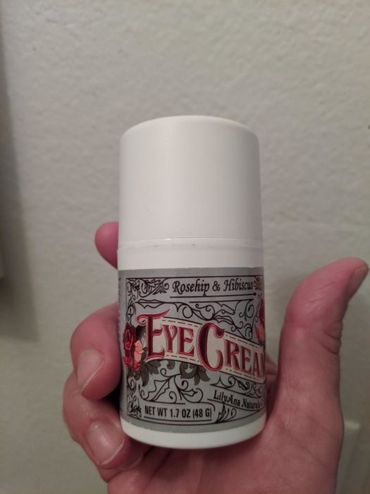 the eye cream bottle being held by a reviewer