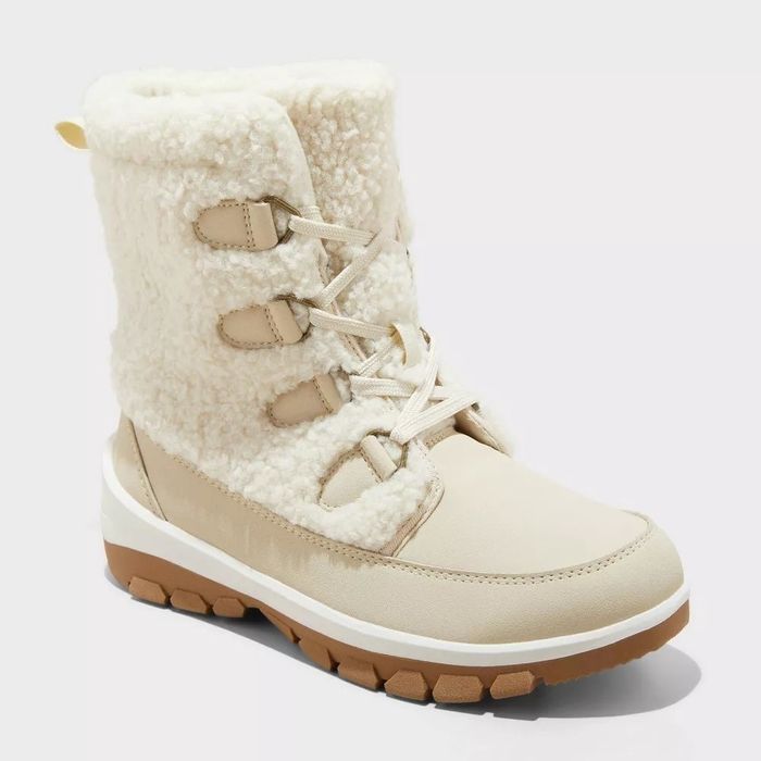 Warm winter boots with faux shearling lining and a sturdy sole, perfect for chilly weather shopping trips