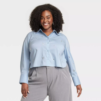 Model wearing the blue collared shirt with crystal beads on it