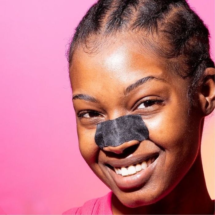 A person using an acne removal strip
