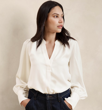 Model in a white long-sleeve blouse