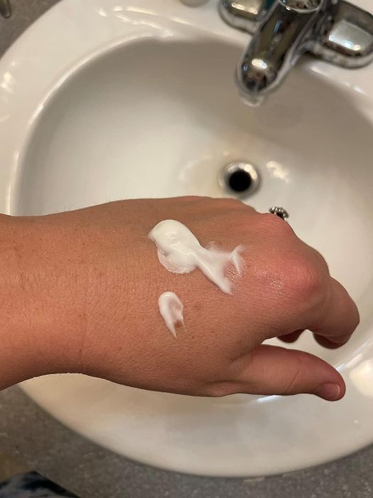 image of a dollop of eye cream on a reviewer's hand