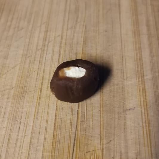 A pill neatly placed inside a pill pocket, perfectly molded to hide the medication.