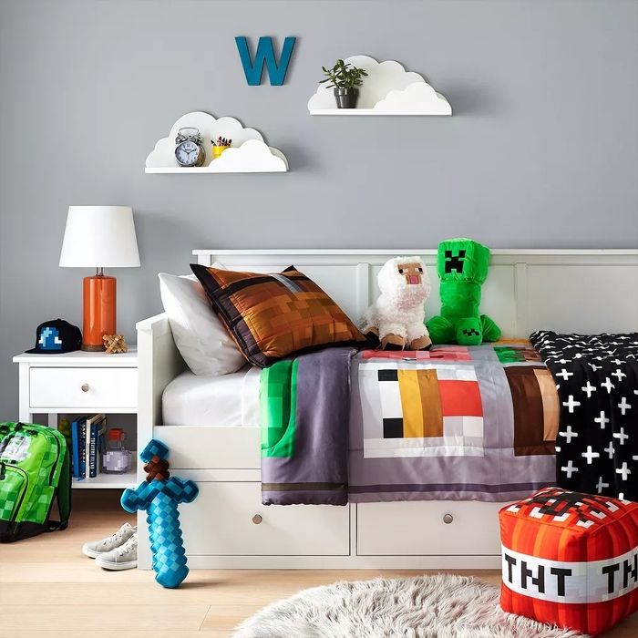 Cloud-shaped shelves positioned above a child's bed on the wall.