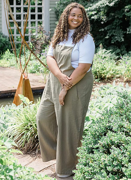 A reviewer styling the sage green romper over a white top