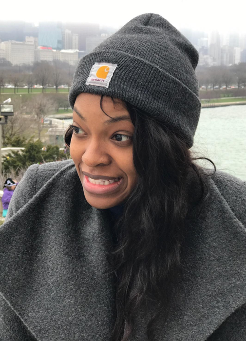 Reviewer in a gray foldover beanie with the Carhartt logo stitched on the front