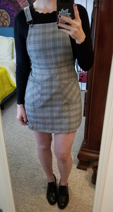 A reviewer flaunting the same dress, but with a black and white plaid pattern