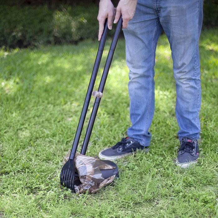 The pooper scooper, featuring a rake and a trash bin for easy disposal