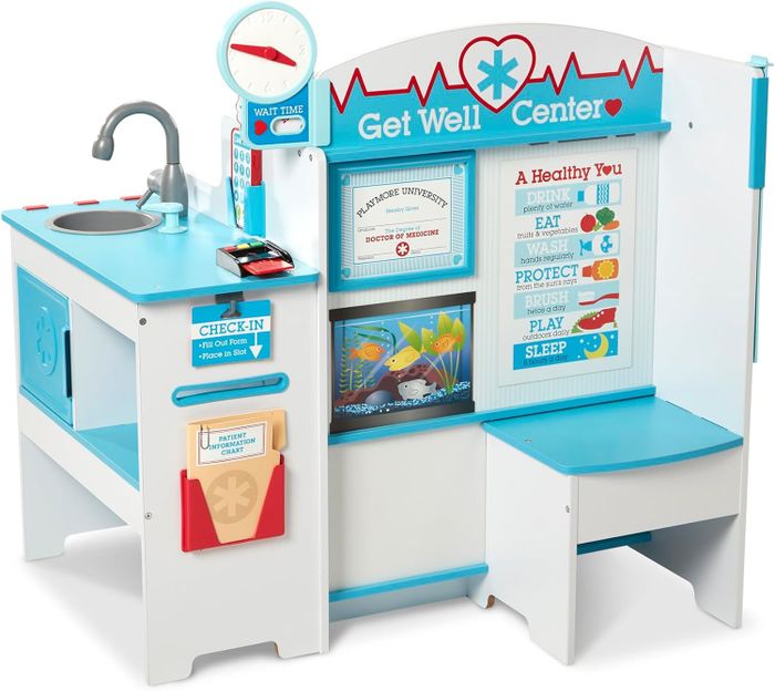 A wooden play medical center with check-in station, sink, and health tips for little doctors