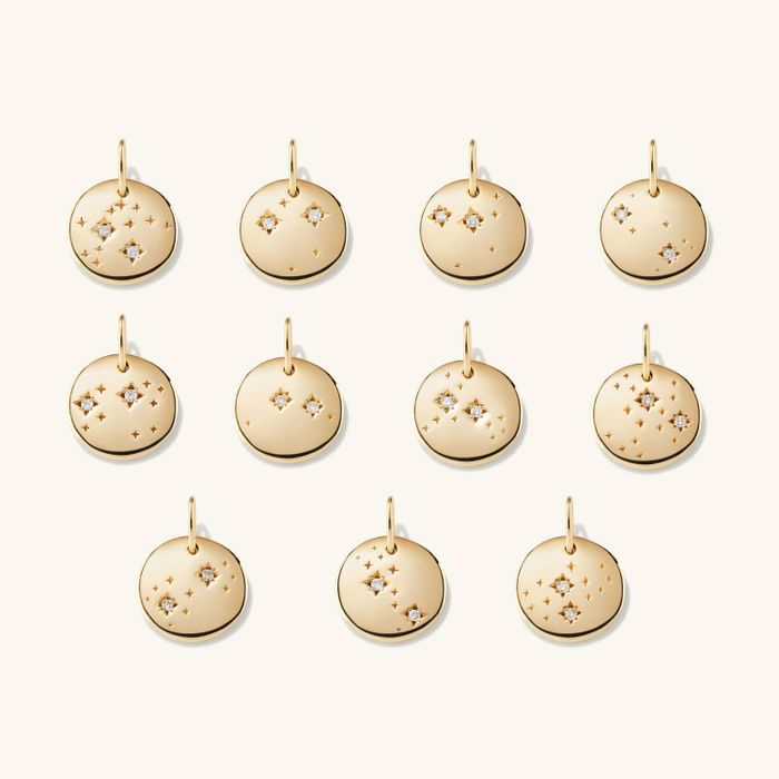 An assortment of constellation-shaped gold pendants, each representing a different zodiac sign