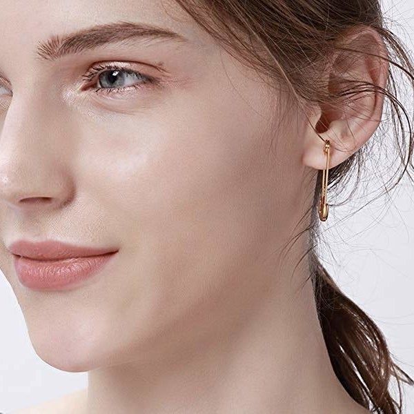 A model wearing the simple, non-rhinestone version of the safety pin earrings