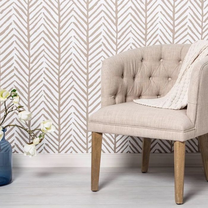 Beige and white peel-and-stick wallpaper featuring a herringbone pattern.
