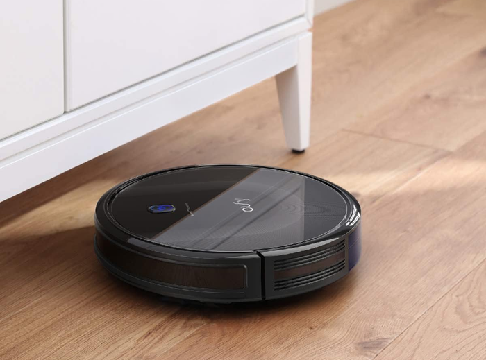 The vacuum cleaning a hardwood floor.