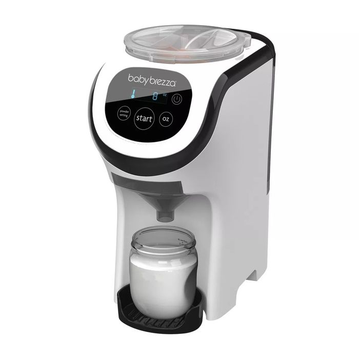 Baby Brezza Formula Pro Advanced dispenser machine with a digital display and a bottle in place