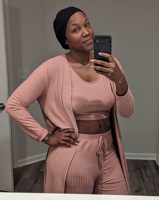 A reviewer modeling the set in a soft light pink color