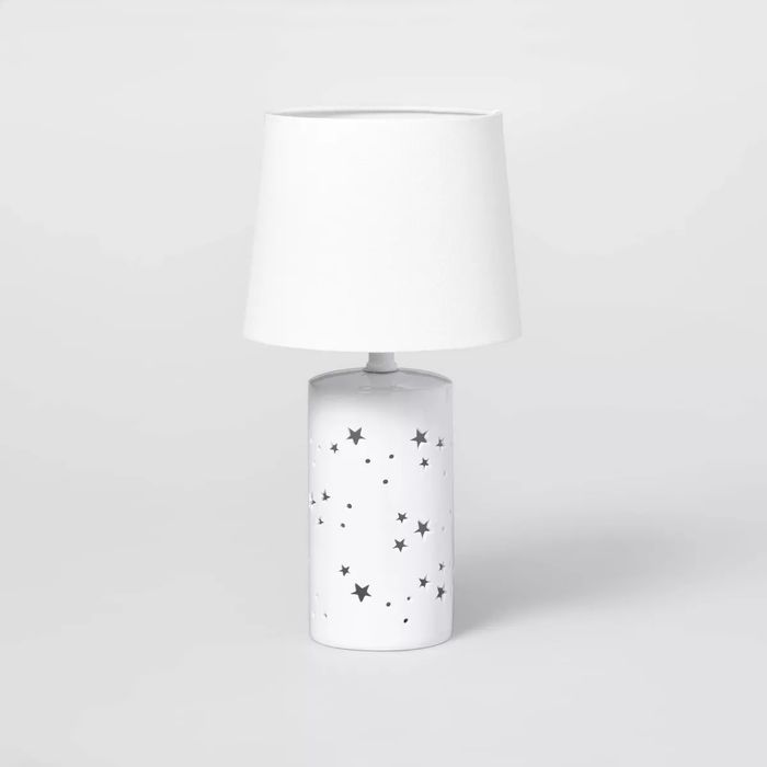 Table lamp featuring a star-patterned base and a simple lampshade.