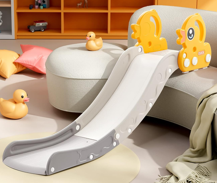Children's slide with duck-shaped handles placed on a sofa