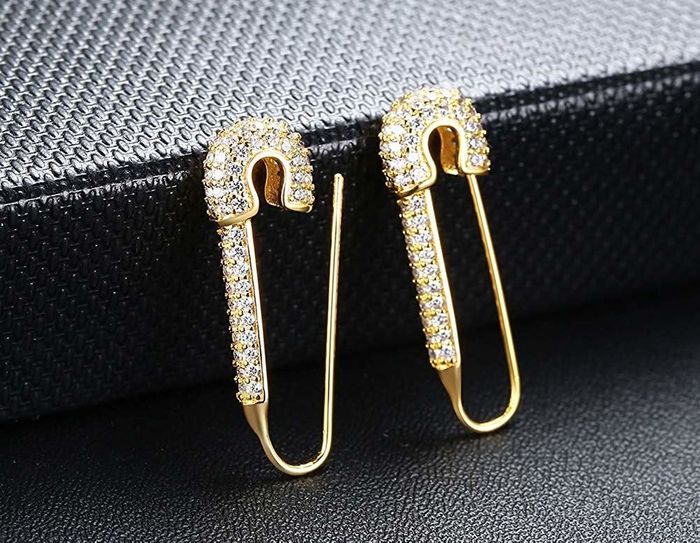 The yellow gold earrings, embellished with clear rhinestones