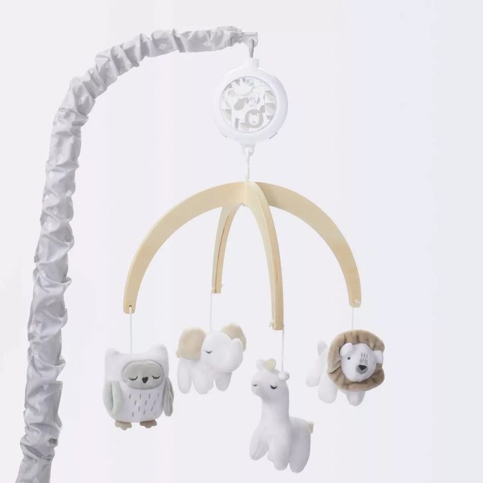 Baby mobile with plush toys of an owl, sheep, llama, and dog, designed for a crib.