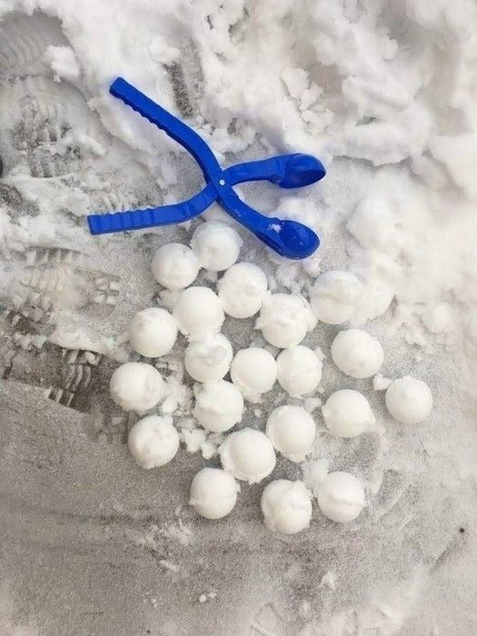 The blue snowball maker next to about 20 perfectly round snowballs.
