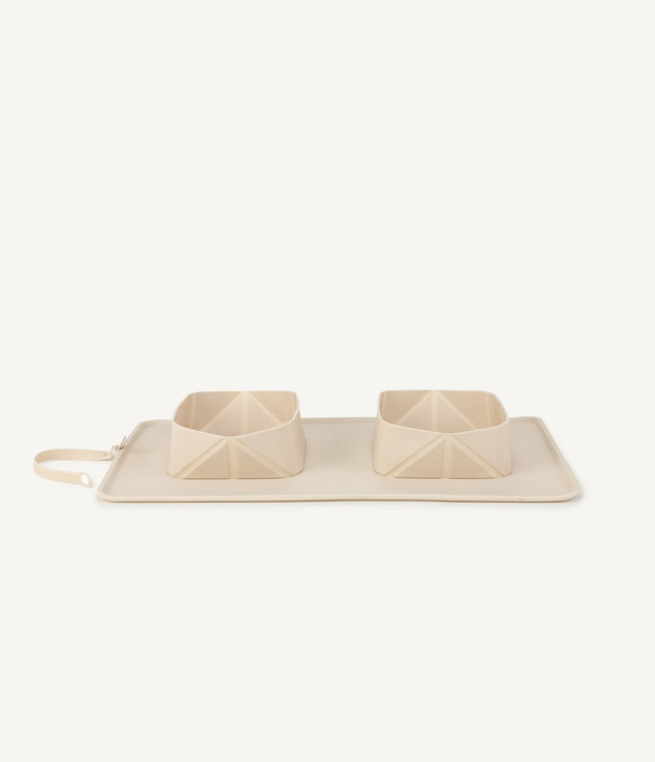 The two silicone bowls neatly placed on a tan mat