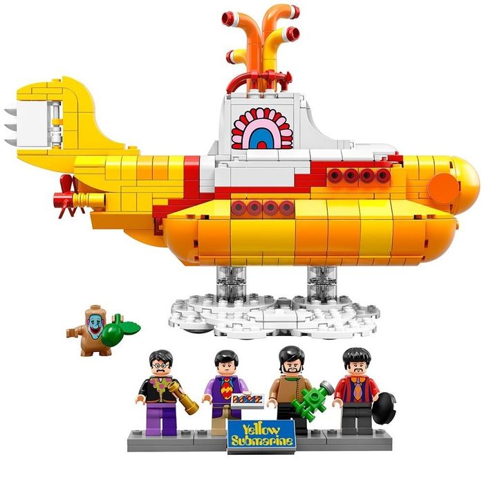 Lego submarine with four Beatles minifigs holding accessories and a tiny Jeremy figure