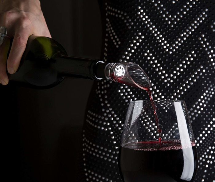 Wine flowing through a small aerator, enhancing its flavor and aroma.