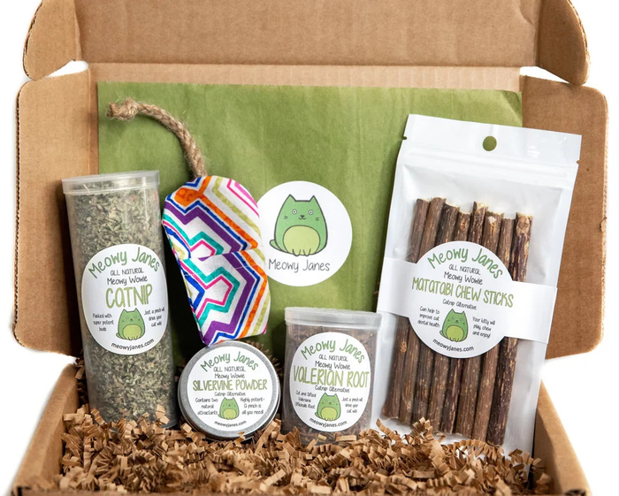 A box of catnip alternatives, featuring valerian, silvervine powder, matatabi sticks, homegrown catnip, and a refillable toy
