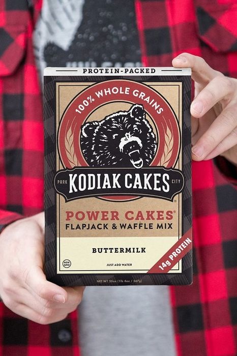 Hands holding a box of Kodiak Cakes Power Cakes