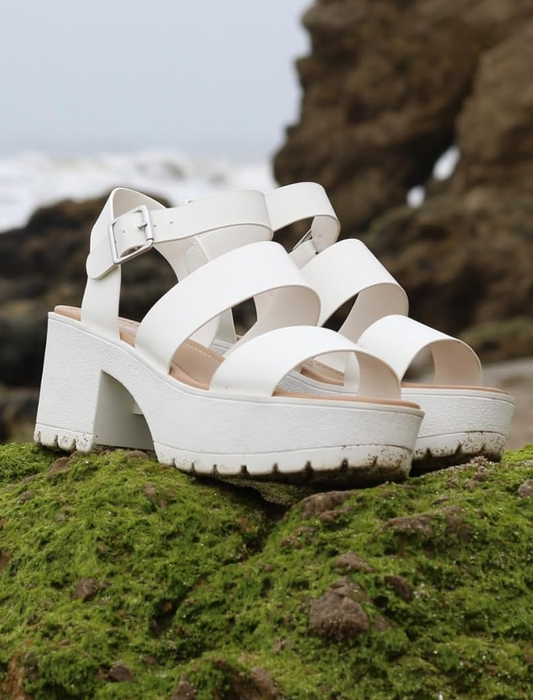 A reviewer wearing white platform sandals