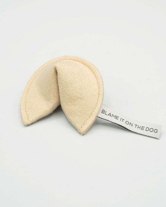 The fortune cookie-shaped toy with a tag that reads