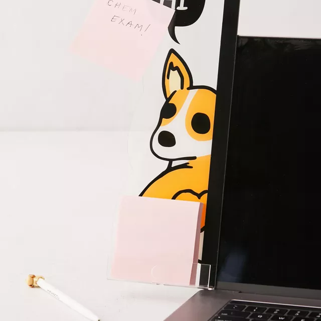 A plastic tab on a laptop featuring a corgi illustration