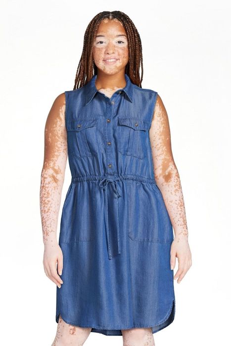 The model is wearing the medium denim dress.