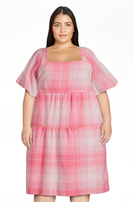 The model is wearing the pink plaid dress.