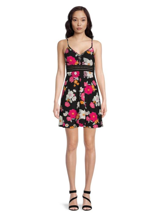 The model is wearing the black patterned dress.