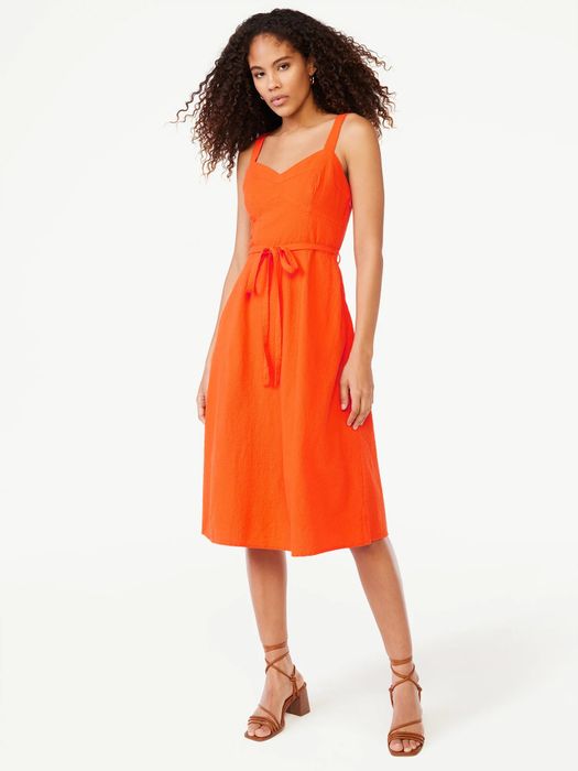 The model is wearing the tangerine tango dress.