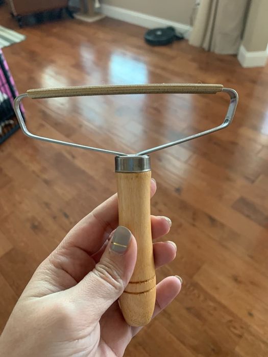Wooden handle with a metal scraper attachment