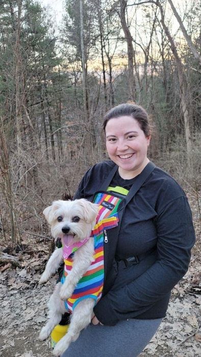 A reviewer using the carrier to carry their dog comfortably