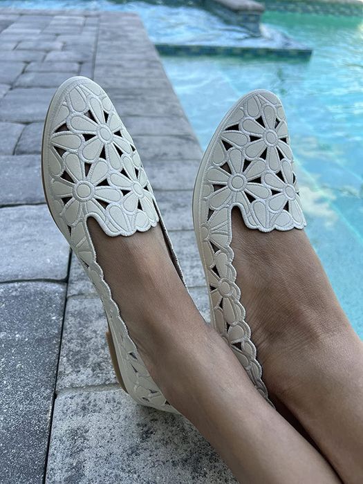 A reviewer’s image of the white floral ballet flats